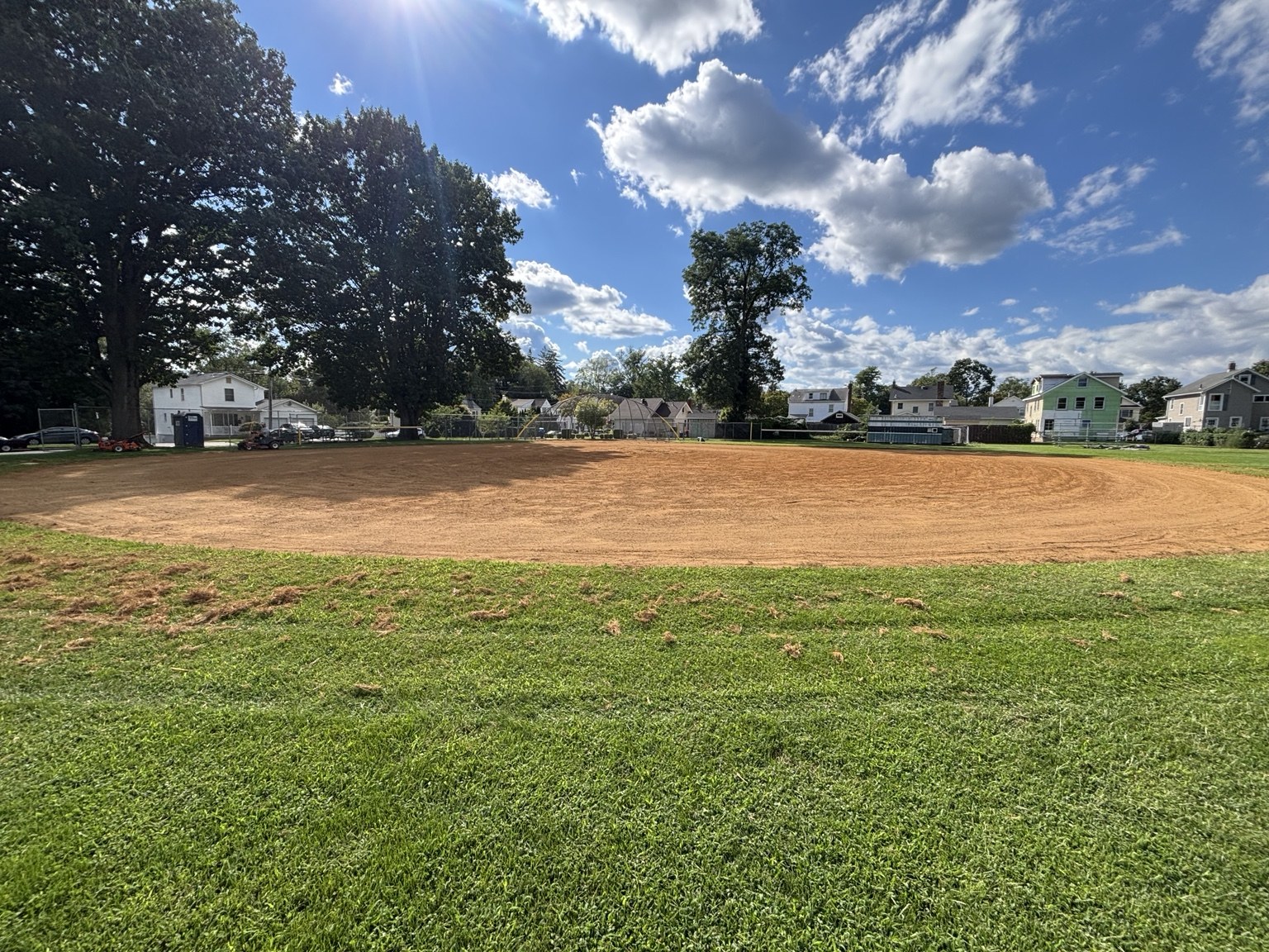 After restoration: cleared and leveled dirt softball infield